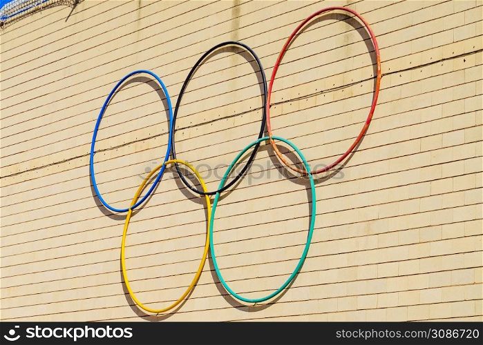 Olympic Games symbol outdoors on wall. Sports competitions.. Olympic Games symbol on wall