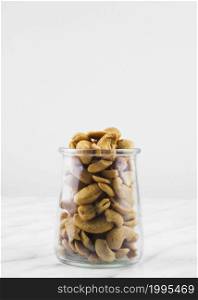 OLYMPUS DIGITAL CAMERA. close up jar filled with fresh cashewnuts