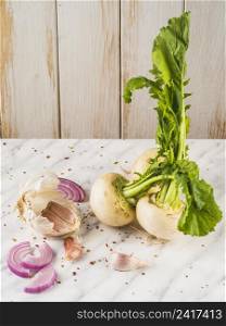 OLYMPUS DIGITAL CAMERA. close up turnip onion slice garlic cloves marble surface