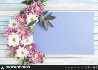 OLYMPUS DIGITAL CAMERA. decorated flowers design blank paper wooden table