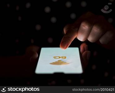 OLYMPUS DIGITAL CAMERA. finger touching phone screen dark background