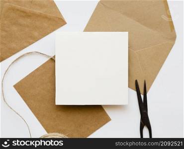 OLYMPUS DIGITAL CAMERA. flat lay arrangement white brown envelopes