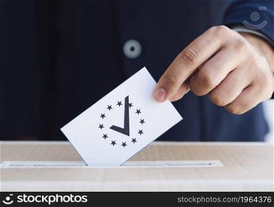 OLYMPUS DIGITAL CAMERA. High resolution photo. man putting ballot box close up. High quality photo