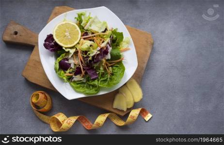 OLYMPUS DIGITAL CAMERA. High resolution photo. vegetable salad wooden board with measuring tape table. High quality photo