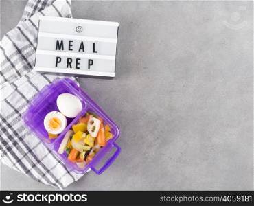 OLYMPUS DIGITAL CAMERA. light board with meal prep inscription near food container
