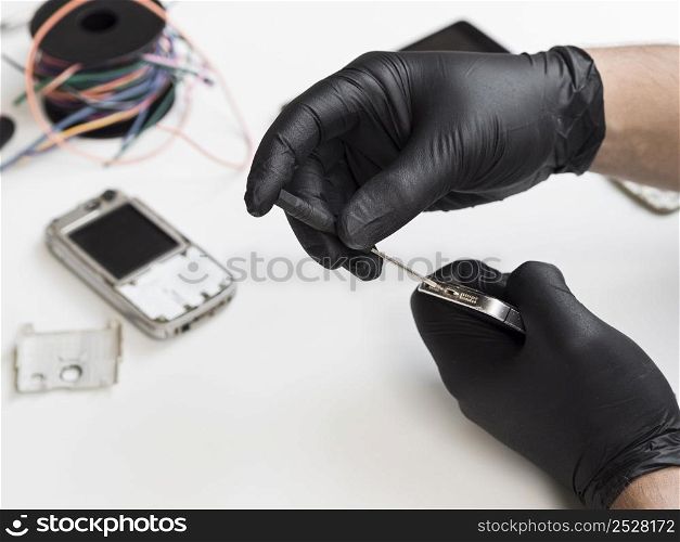 OLYMPUS DIGITAL CAMERA. man removing screws open up phone