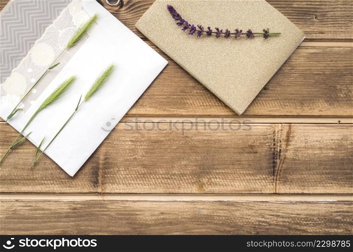 OLYMPUS DIGITAL CAMERA. overhead view green ears wheat greeting card lavender twig wooden table