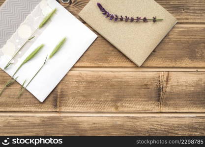 OLYMPUS DIGITAL CAMERA. overhead view green ears wheat greeting card lavender twig wooden table