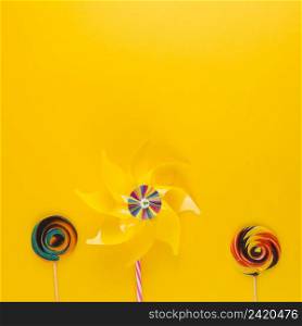 OLYMPUS DIGITAL CAMERA. pinwheel with swirl lollipops yellow backdrop