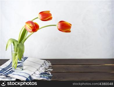 OLYMPUS DIGITAL CAMERA. red tulips glass vase table