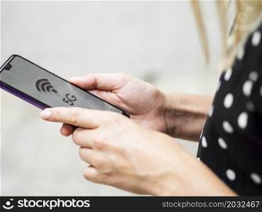 OLYMPUS DIGITAL CAMERA. side view woman holding phone hands