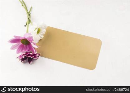 OLYMPUS DIGITAL CAMERA. small bouquet with gift card placed white desk