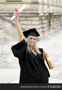 OLYMPUS DIGITAL CAMERA. smiley young woman wearing graduation gown