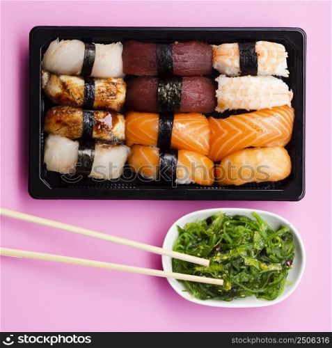 OLYMPUS DIGITAL CAMERA. sushi set box with seaweed salad rose background