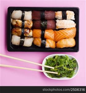 OLYMPUS DIGITAL CAMERA. sushi set box with seaweed salad rose background