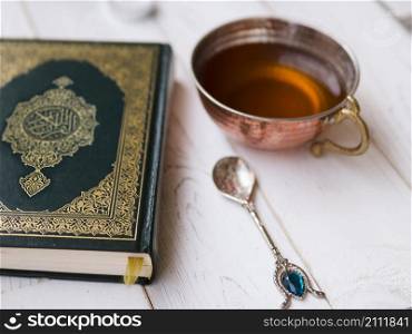 OLYMPUS DIGITAL CAMERA. top view arrangement with quran tea spoon