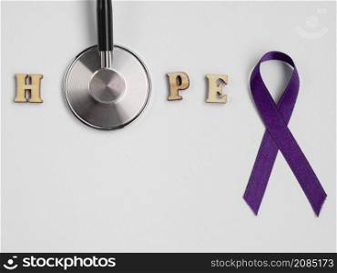 OLYMPUS DIGITAL CAMERA. top view purple ribbon with stethoscope