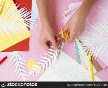 OLYMPUS DIGITAL CAMERA. top view woman making paper decorations