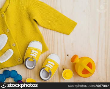 OLYMPUS DIGITAL CAMERA. top view yellow sweater with toys