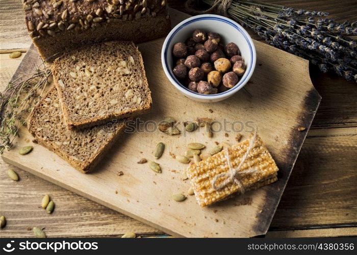 OLYMPUS DIGITAL CAMERA. view fresh organic bread with ingredients energy bar chopping board