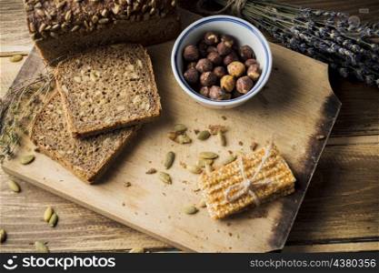 OLYMPUS DIGITAL CAMERA. view fresh organic bread with ingredients energy bar chopping board