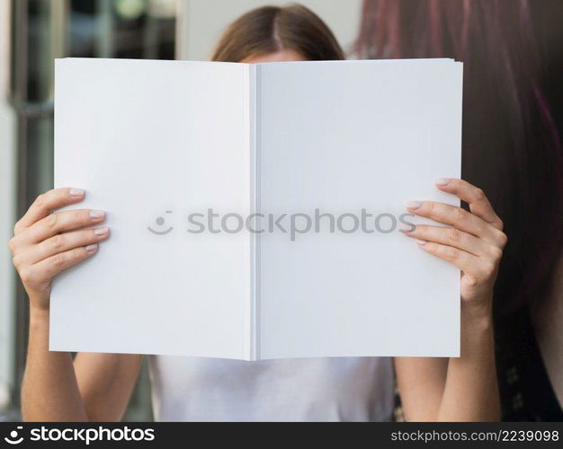 OLYMPUS DIGITAL CAMERA. woman holding mock up magazine 2