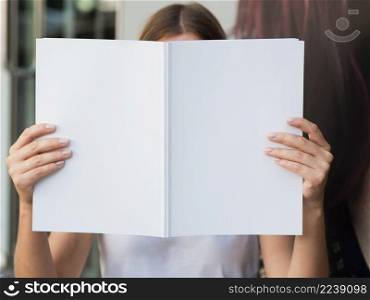 OLYMPUS DIGITAL CAMERA. woman holding mock up magazine 2