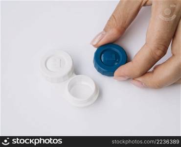 OLYMPUS DIGITAL CAMERA. woman opening contact lenses box