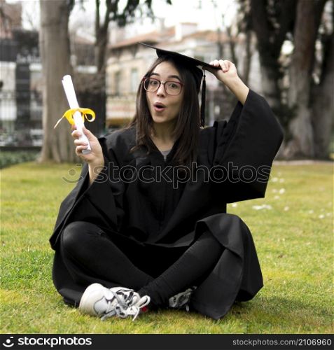 OLYMPUS DIGITAL CAMERA. young woman graduation ceremony holding her cap