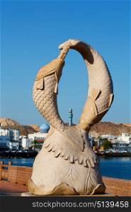 oman musact old statue of fish in the sea and clear sky