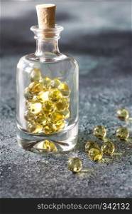 Omega-3 fish oil capsules in the glass bottle