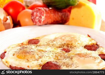 Omelet from eggs on white plate close up