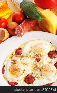 Omelet from eggs on white plate close up