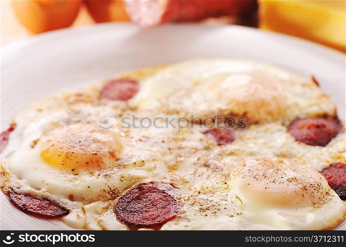 Omelet from eggs on white plate close up