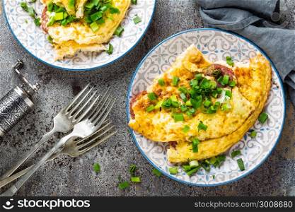 Omelet or omelette with fresh green onion, scrambled eggs