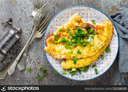 Omelet or omelette with fresh green onion, scrambled eggs