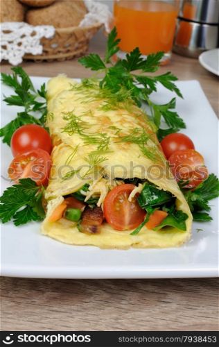 Omelet stuffed with vegetables herbs and tomatoes