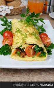 Omelet stuffed with vegetables herbs and tomatoes