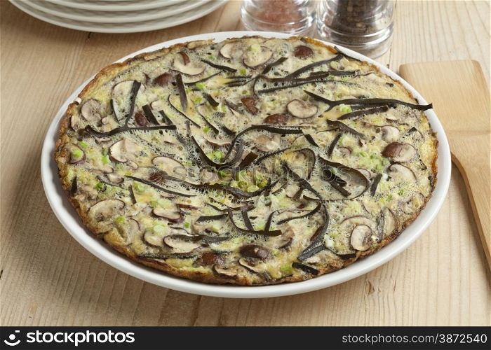Omelet with sea spaghetti, mushrooms and spring onions