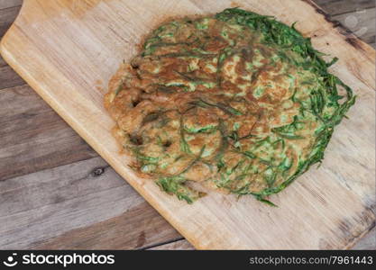 Omelet with vegetables,Climbing Wattle,Thai food on wooden chopping block