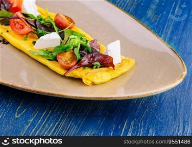 Omelette with cherry tomatoes and goat cheese