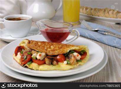 Omelette with cherry tomatoes, mushrooms and feta cheese