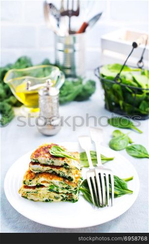 omelette with spinach. omelette with spinach leaves, diet food, omelette on plate