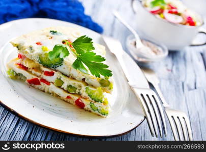 omelette with vegetables on plate on a table