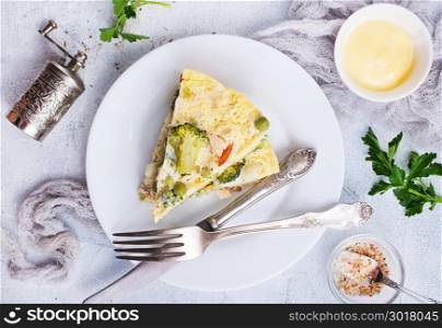 omelette with vegetables on white plate, stock photo