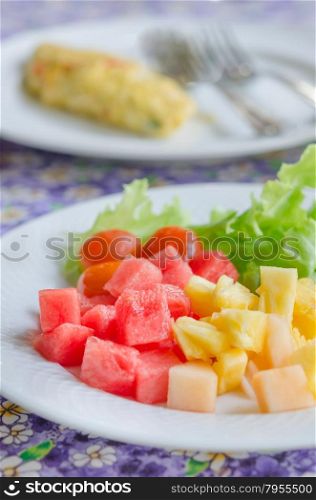 omlette and fruit salad. A breakfast with mix fruit salad