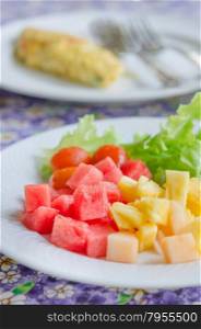 omlette and fruit salad. A breakfast with mix fruit salad