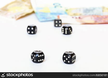 On a white background are clearly visible two dice for the game of poker. Three cubes and banknotes can be seen in the background.