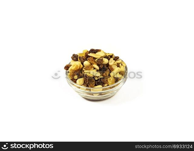 On a white background there is a glass salad bowl with a mixture of nuts, raisins and candied fruits