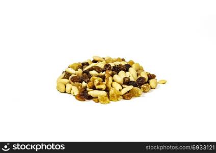 On a white background there is a handful of a mixture of nuts, raisins and candied fruits